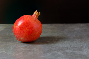  Red pomegranate resting on the ground