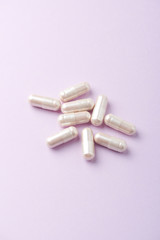 Carnitine capsules. Concept for a healthy dietary supplementation. Bright paper background. Copy space. 