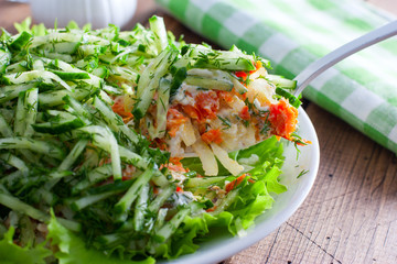 Norwegian salad salad of canned fish and fresh cucumber, selective focus
