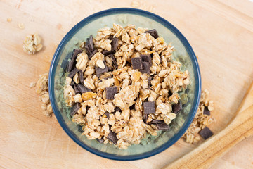 Cereal bowl with wooden spoon on craft board