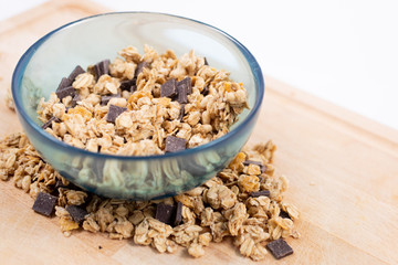 Cereal bowl with wooden spoon on craft board