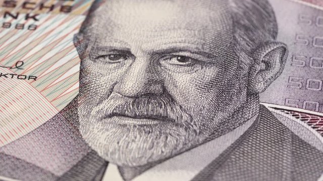 Sigmund Freud portrait on Austria 50 schilling banknote rotating. Low angle, macro. 4K, 422 10 bit