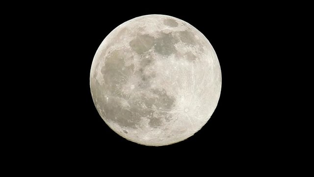 Rising full supermoon in perigee on a dark and cloudless nightsky in February, also called the snowmoon.