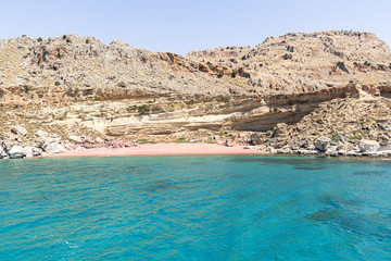 Empty Red Sand beach accessible only by boat (Rhodes, Greece)