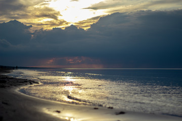Sea ocean landscape at sunset with volumetric light (god rays) Baltic shore coast at dusk