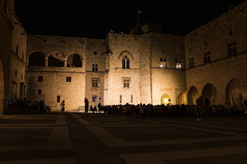 Audience of musical performance in Courtyard of Grand Master Palace in city of Rhodes (Rhodes, Greece)