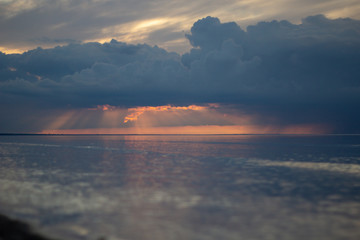 Sea ocean landscape at sunset with volumetric light (god rays) Baltic shore coast at dusk