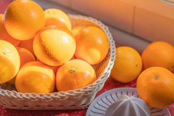 Basket of fresh and natural oranges with juicer