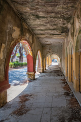 Fototapeta premium Column corridor of deserted building of sanatorium in Italian village of Eleousa (Rhodes, Greece)