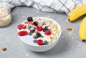 Healthy breakfast. Smoothie bowl with yogurt, blue water, banana, Chia, strawberries, raspberries, blueberries and almonds. Vegan food