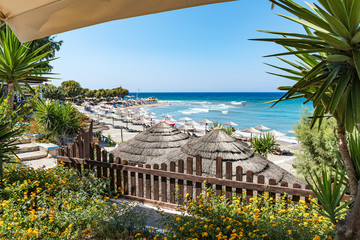 View of beach near ancient city of Kamiros from terrace with flowers (Rhodes, Greece)