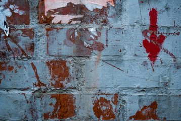 Texture of an old paint covered brick wall. Background image of an abandoned brick wall with painted over paint