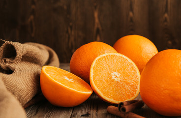  Ripe juicy oranges on an old wooden table copy space. Halves of oranges.