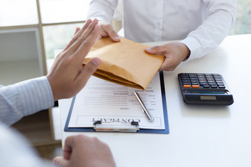 Businessman refusing to receive the money in a brown envelope to sign a business contract ,Anti...