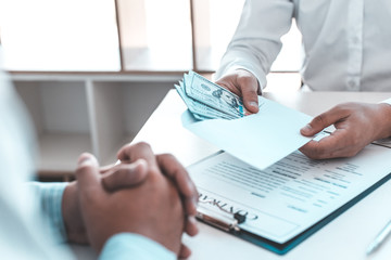  Businessmen make dollar payments while signing an investment agreement to be a partner in an illegal and successful manner, Bribery and corruption concept..