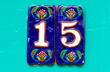 House Number 15 on turquoise wooden Door