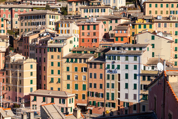 Group of palaces facades of Camogli, painted with famous pastel colors. Camogli is a small fisherman village on the shores of the Ligurian Sea. (Northern Italy).