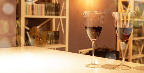 Two glasses of red wine in a cozy interior