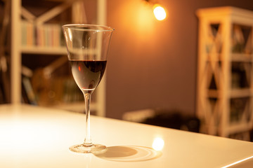Glass of red wine in a cozy interior
