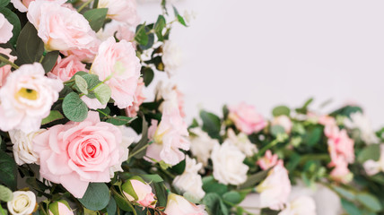 Beautiful rose flowers on a light background. Floral frame in soft colors with white space for text. Art flower background for greeting card for Mother's Day and Valentine's day