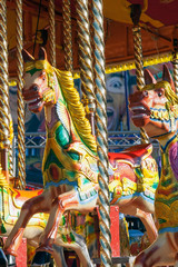 Fototapeta na wymiar Carousel horses at funfair