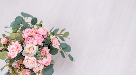 Beautiful rose flowers on a light background. Floral frame in soft colors with white space for text. Art flower background for greeting card for Mother's Day and Valentine's day