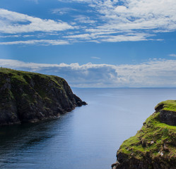 Fototapeta na wymiar Rugged Donegal cliffs with bright blue sea and sky.
