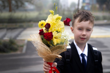 Boy with flowers for teacher on September 1.