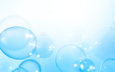 Blue bubbles float on a white background