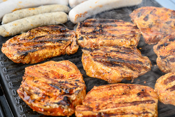 Barbecue grill bbq on coal charcoal grill with steaks bratwurst sausages and meat delicious summer meal