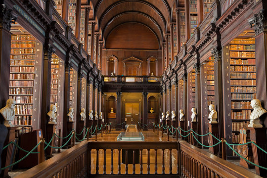DUBLIN, IRELAND - FEB 15, 2014: Old books on shelves in the Long Room library in the Trinity College.
