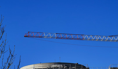 Crane on a construction site against blue sky
