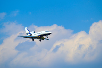 Small private jet airplane preparing for landing at day time in international airport