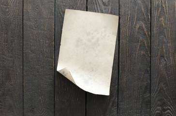 old paper on dark wooden wall