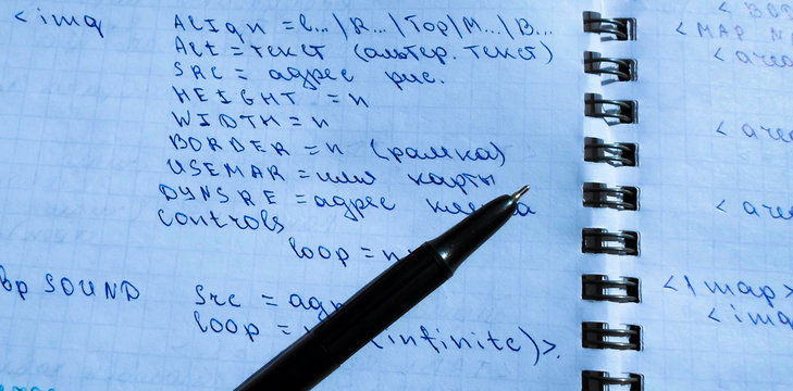 translations of calculus systems on a notebook and black pen. creation of computer programs. work of the programmer and system administrator