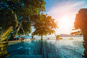 Swimming pool at exotic tropical resort. Exotic garden.