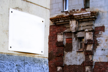 Empty plate on an old brick wall, restoration of an old building.