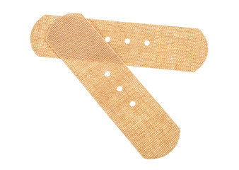 Top view of two beige adhesive bandages isolated on a white background