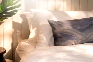 Bed maid-up with clean white pillows and bed sheets in beauty bedroom. Close-up. interior background