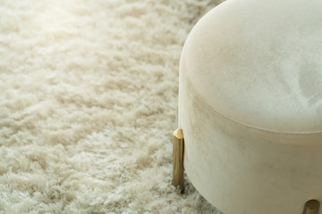 close up armchair gold brass leg on carpet rug living room