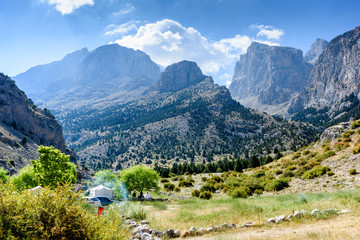 Fototapeta na wymiar Mountain landscape with trees, tents, cars in the Turkish national Park aladag in summer day
