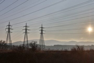 High voltage electric pole and transmission lines in the evening. Electricity pylons at night. Power and energy. Energy.