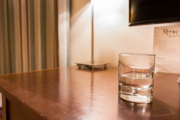 Hotel room water and coffee on a wooden table.