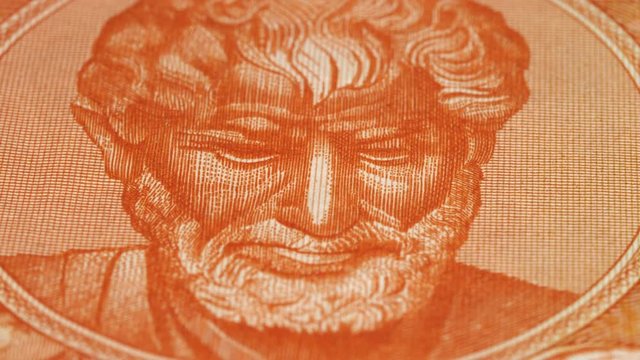 Aristotle portrait on 10000 Greece drachma (1947) banknote rotating. Famous ancient Greek philosopher. Low angle, macro. 4K, 422 10 bit