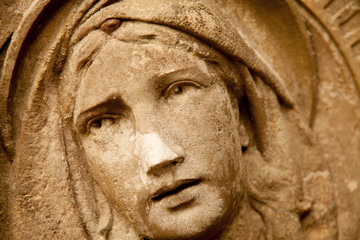 The look of love and eyes of Virgin Mary. Fragment of ancient statue.