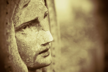 Virgin Mary. Antique statue. Portrait in profile.