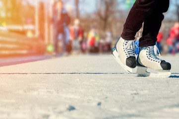 Fototapeta na wymiar Legs of skater on ice rink
