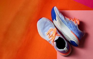 sneaker or running shoe on pink and orange floor with copy test space,top view