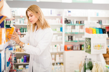 Female pharmacist arranging medicines