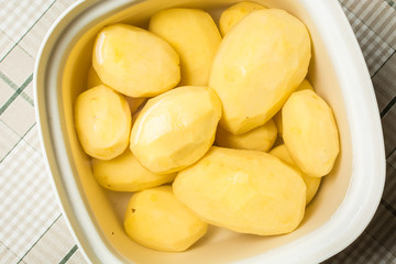 Cleaned potatoes lie in water from blackening of nitrates.